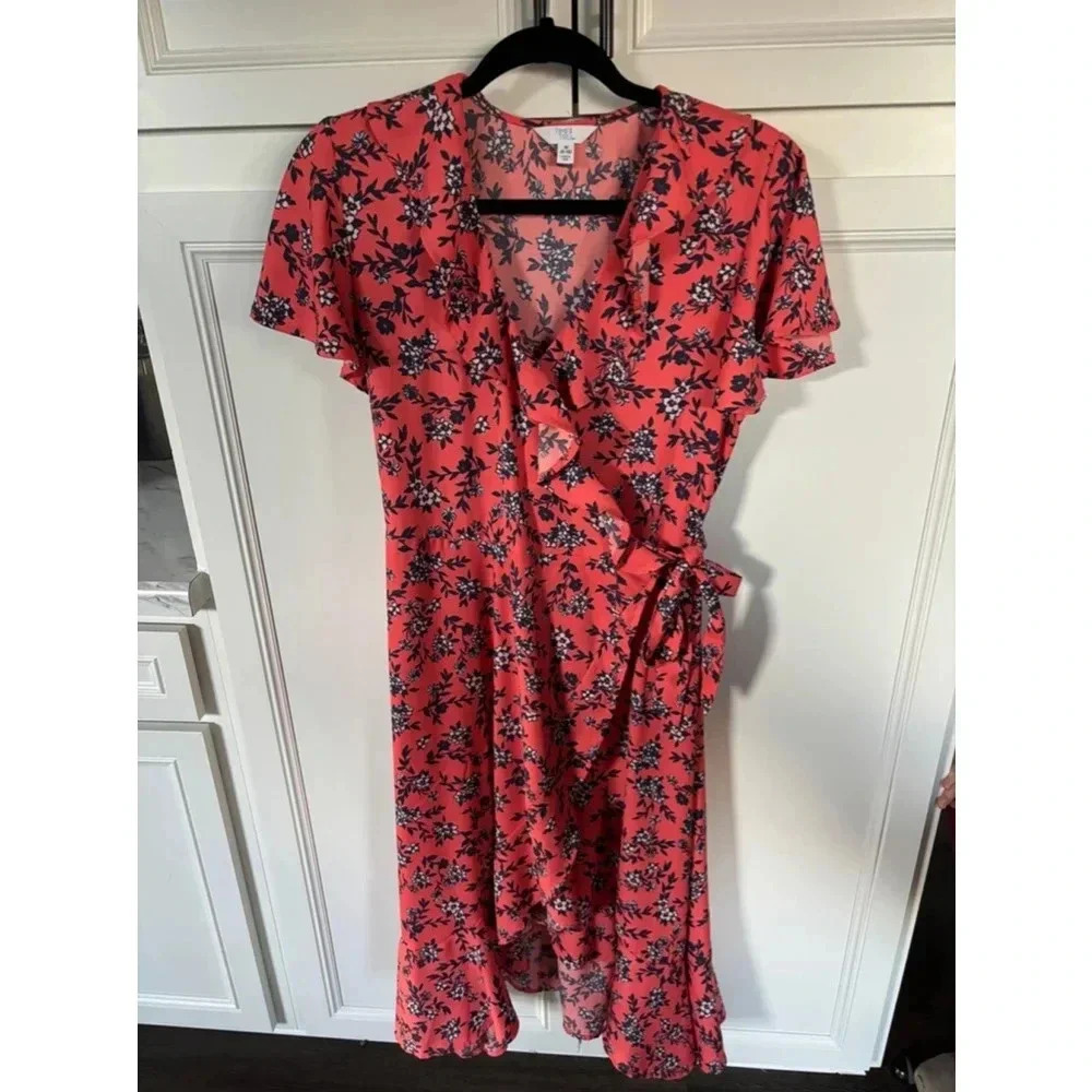 Women’s wrap coral and navy dress with ruffles; subtle high low hem